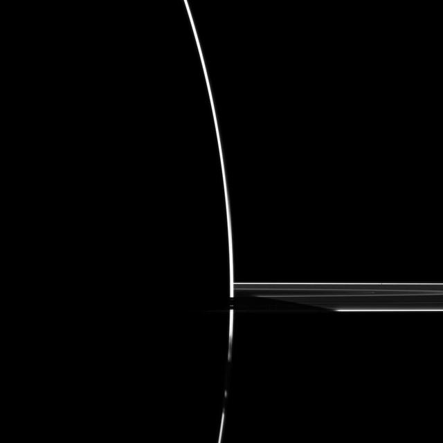 Although the sun is on the other side of Saturn in this dramatic image, some sunlight scatters through the uppermost part of the atmosphere to reach NASA Cassini spacecraft cameras.