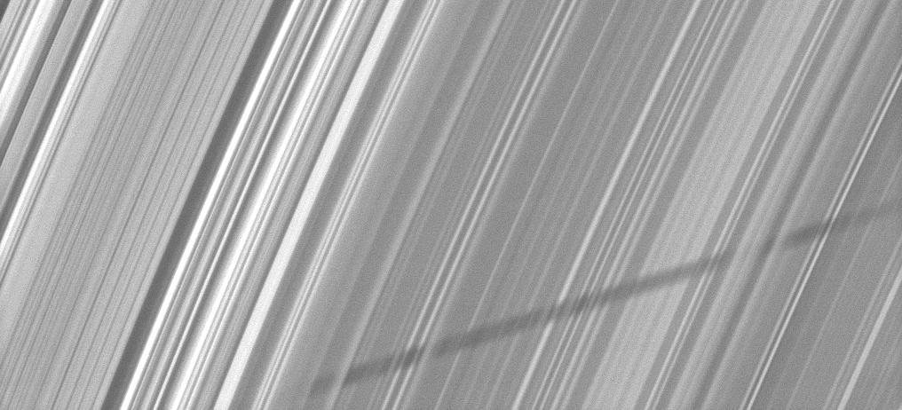Part of the shadow of Saturn moon Epimetheus appears as if it has been woven through the planet rings in this image taken about a month and a half before the planet August 2009 equinox by NASA Cassini spacecraft.