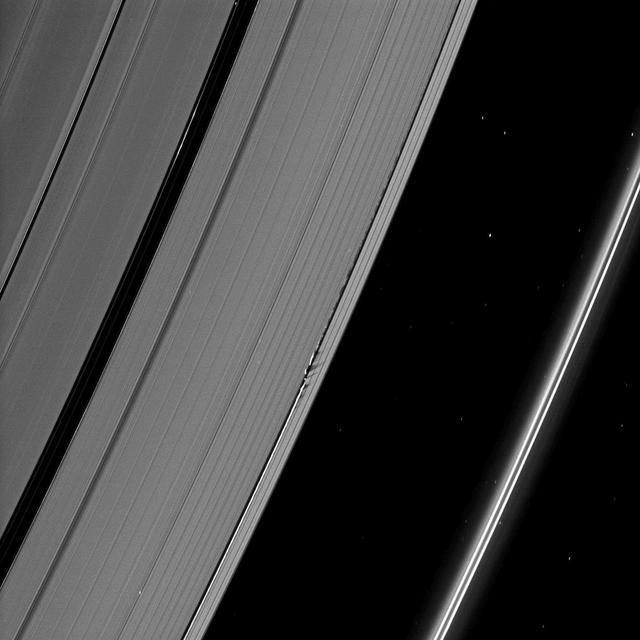 Shadows are cast by Daphnis and the moon attendant edge waves in this image from NASA Cassini spacecraft taken about a month and a half before the Saturn August 2009 equinox.