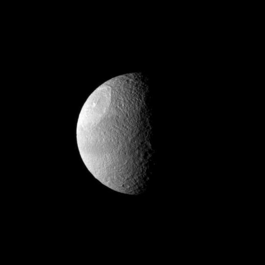 A huge impact created Odysseus Crater, which covers a large part of Saturn moon Tethys in this image from NASA Cassini spacecraft.