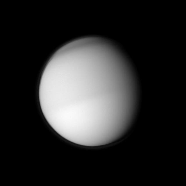 Two different seasons on Titan in different hemispheres can be seen in this image. The moon northern half appears slightly darker than the southern half in this view taken in visible blue light by NASA Cassini spacecraft.