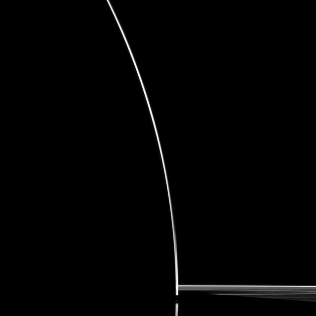 A startling silhouette of Saturn is created in this NASA Cassini spacecraft portrait.