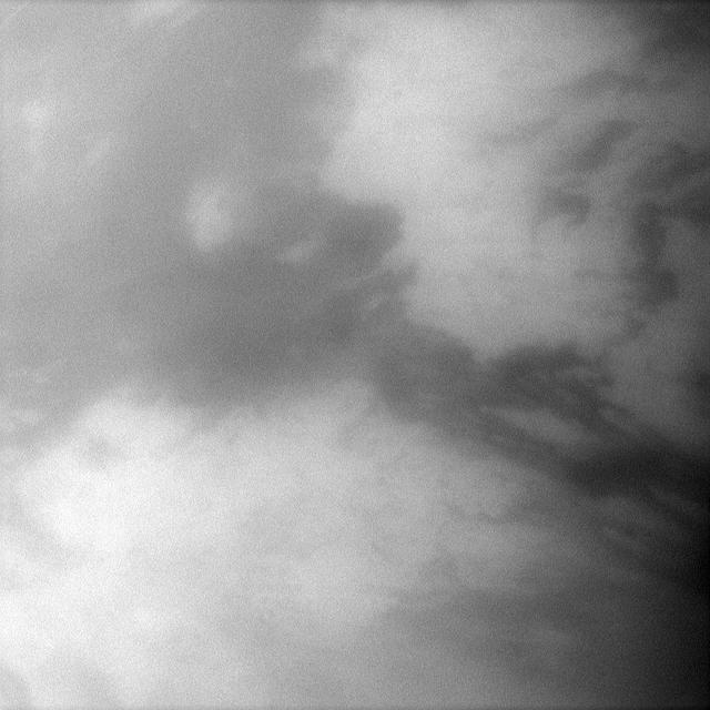 NASA Cassini spacecraft peers through the atmosphere of Saturn largest moon, Titan, to examine the dark region Belet. This large region on the moon surface has a low albedo, meaning it reflects little light.