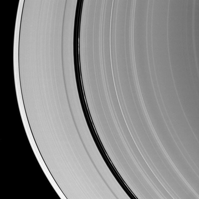 Kinky, discontinuous ringlets occupy the Encke Gap in Saturn A ring in the middle of this NASA Cassini spacecraft image; parts of these thin ringlets cast shadows onto the A ring.