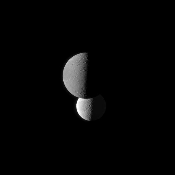 Saturn moon Dione, in the foreground of this image from NASA Cassini spacecraft, appears darker than the moon Tethys. Tethys appears brighter because it has a higher albedo than Dione, meaning Tethys reflects more sunlight.