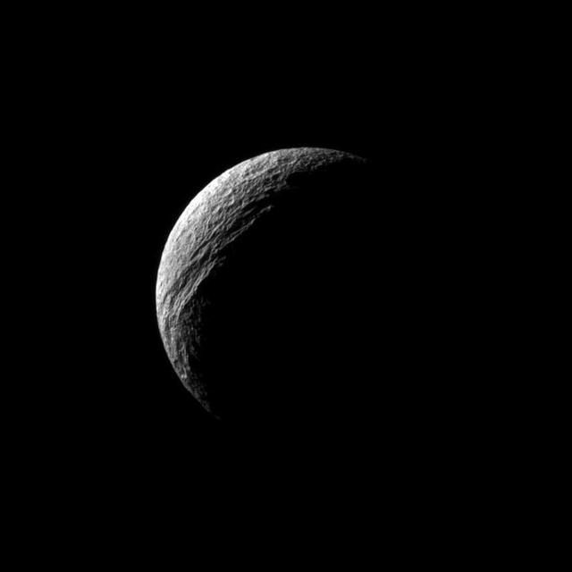 Sunlight illuminates the deep cut of Ithaca Chasma on Saturn moon Tethys. Ithaca Chasma runs roughly north-south for more than 1,000 kilometers 620 miles on Tethys in this image captured by NASA Cassini spacecraft.