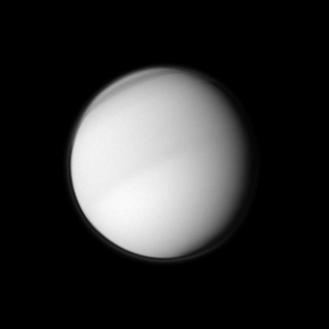 NASA Cassini spacecraft examines the characteristics of Titan atmosphere as it peers at Saturn largest moon using a filter sensitive to visible violet light.