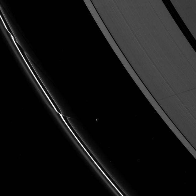 Saturn moon Prometheus casts a long shadow across the A ring in the middle-right side of this image taken shortly before the planet August 2009 equinox by NASA Cassini spacecraft.