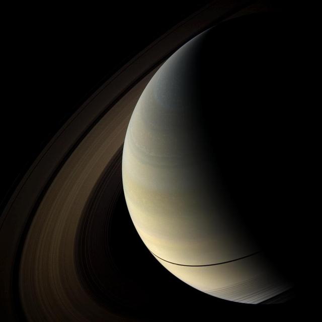 The shadows of Saturn rings cast onto the planet appear as a thin band at the equator in this image taken by NASA Cassini spacecraft as the planet approached its August 2009 equinox.