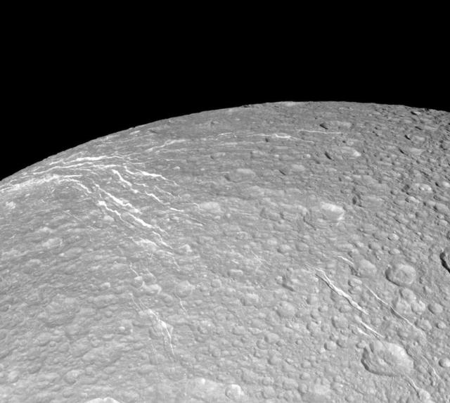 NASA image: Looking Over Dione Wisps