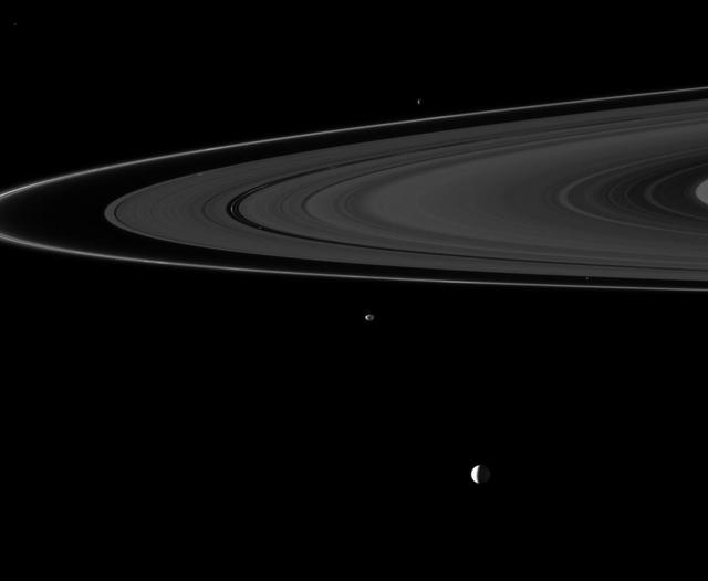Six of Saturn moons orbiting within and beyond the planet rings are collected in this Cassini spacecraft image; they include Enceladus, Epimetheus, Atlas, Daphnis, Pan, and Janus.