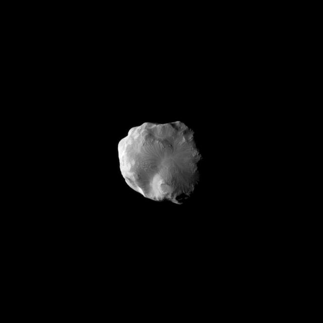 NASA Cassini spacecraft imaged the surface of Saturn moon Helene as the it flew by the moon on Jan. 31, 2011. Helene is a Trojan moon of Dione, named for the Trojan asteroids that orbit 60 degrees ahead of and behind Jupiter as it circles the Sun.