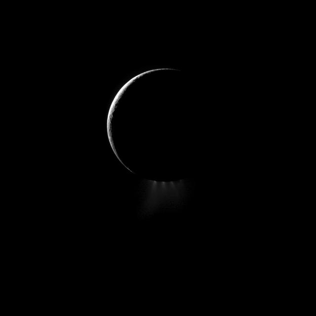 A crescent Enceladus, imaged by NASA Cassini spacecraft from the night side, shows off its spectacular water ice plumes emanating from the south polar region of this moon of Saturn.
