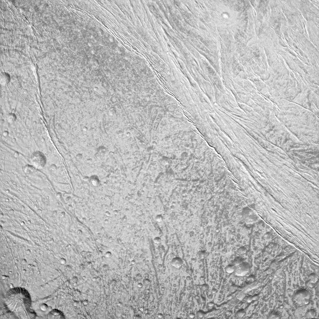NASA Cassini spacecraft surveys the surface of Saturn moon Enceladus in this image, which shows newly created terrain in the upper right meeting older, cratered terrain in the lower left.