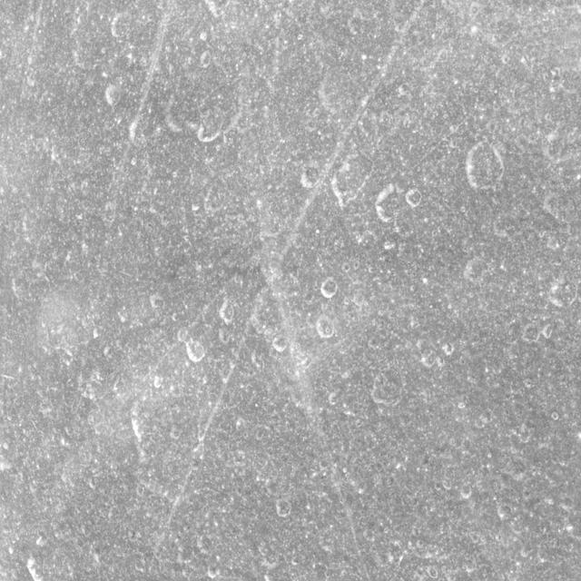 Thin lineaments cross back and forth, intersecting craters on the surface of Saturn moon Rhea in this equatorial view captured by NASA Cassini spacecraft.