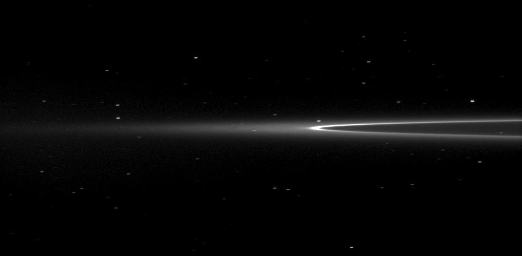 NASA Cassini spacecraft looks toward Saturn tiny moon Aegaeon within the G-ring arc. The moonlet Aegaeon formerly known as S/2008 S 1 cant be seen in this image, but it orbits in the bright arc of Saturn faint G ring shown here.
