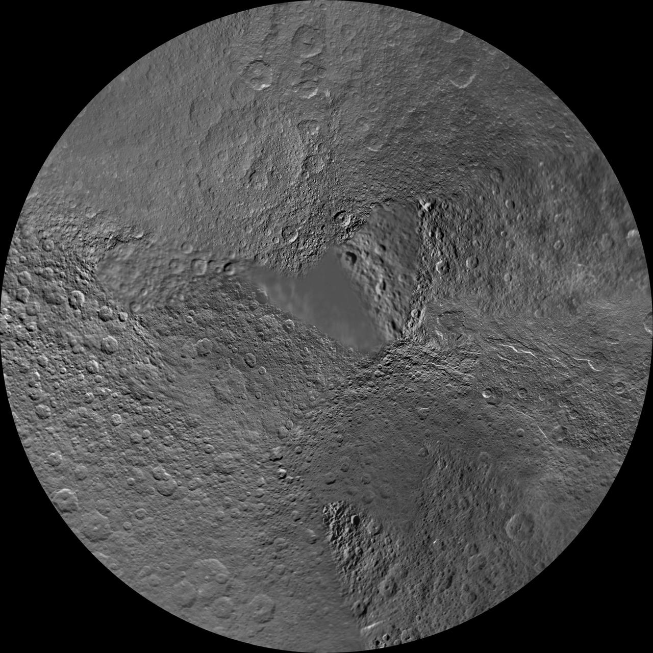 The northern hemisphere of Saturn moon Rhea is seen in this polar stereographic map, mosaicked from the best-available images obtained by NASA Cassini and Voyager spacecraft.