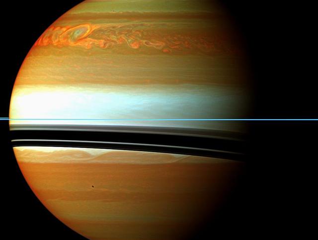 This false-color mosaic from NASA Cassini spacecraft shows the tail of Saturn huge northern storm. The head of the storm is beyond the horizon in this view.