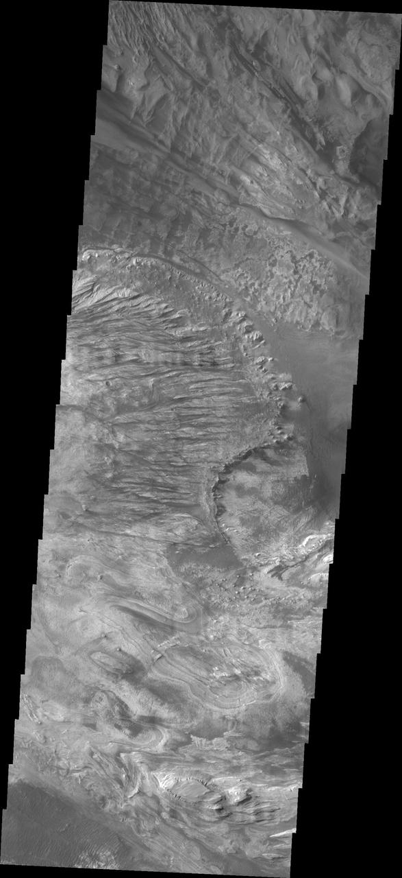 NASA 2001 Mars Odyssey spacecraft took this image of Candor Chasma showing a complex region of eroded layered deposits.