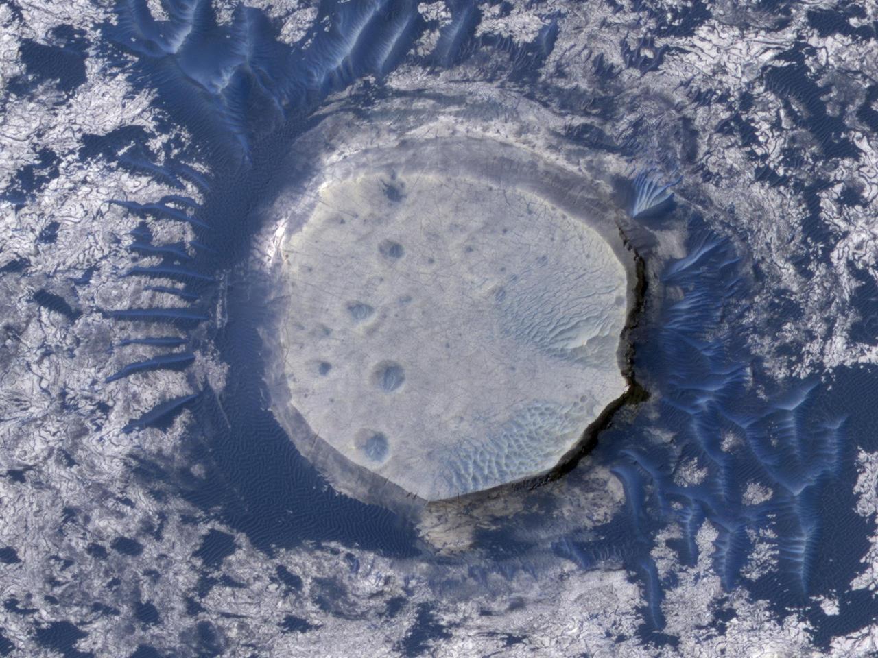 This view of an inverted crater in the Arabia Terra region of Mars is among the images taken by NASA Mars Reconnaissance Orbiter in early 2010 as the spacecraft approached the 100-terabit milestone in total data returned.