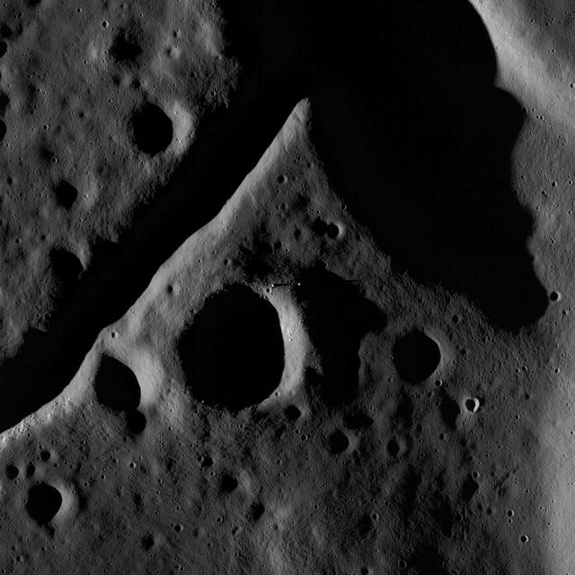 The central peak and fractured floor of Compton crater as imaged by the LROC Narrow Angle Camera onboard NASA Lunar Reconnaissance Orbiter at dusk, image width is ~1720 meters.