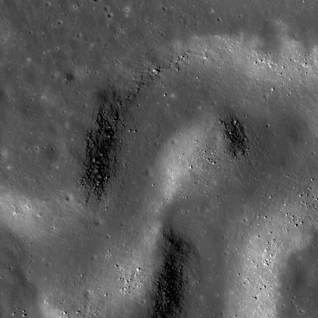 NASA Lunar Reconnaissance Orbiter shows a sinuous rille winding its way across a much larger rille in the heart of the Aristarchus Plateau.