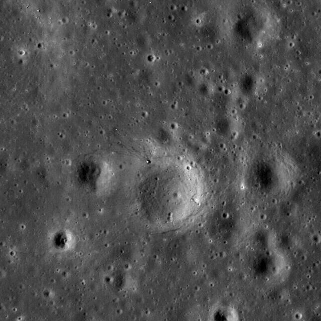 Boulders perched on the summit of the central peak of Tsiolkovskiy crater are seen in this image from NASA Lunar Reconnaissance Orbiter.