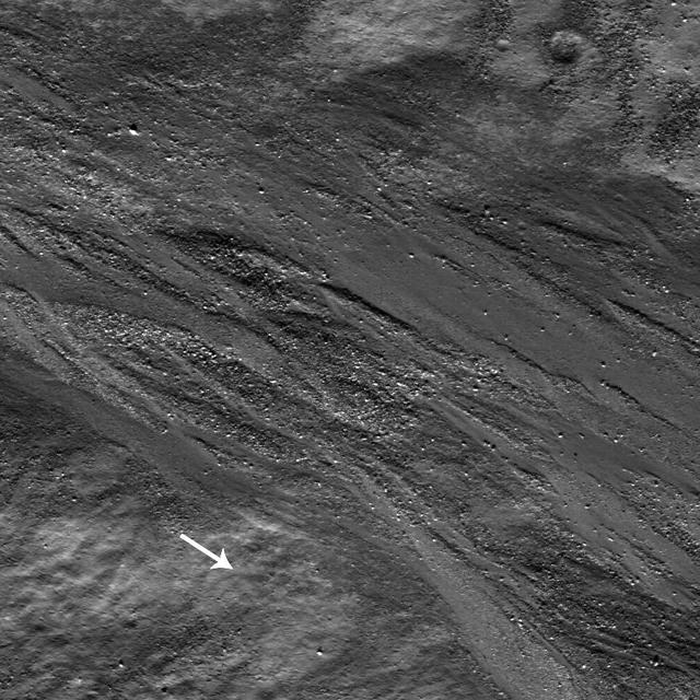 High-albedo marks on the lunar surface left by a boulder bouncing down the northeast wall of farside highlands crater Moore F in this image captured by NASA Lunar Reconnaissance Orbiter.