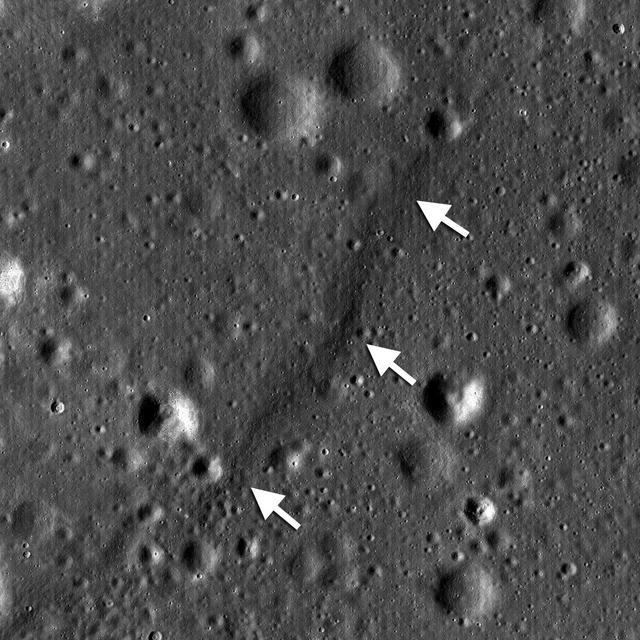 NASA Lunar Reconnaissance Orbiter shows a lobate scarp in the mare basalts of Aitken crater on the lunar farside arrows.