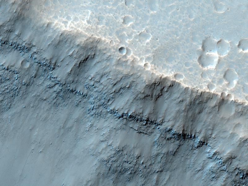 This image taken by NASA Mars Reconnaissance Orbiter reveals meter-scale yard-scale surface textures of mesas and knobs in the Aureum Chaos region of Mars. Aureum Chaos is a wide region of plateaus, mesas, and knobs.
