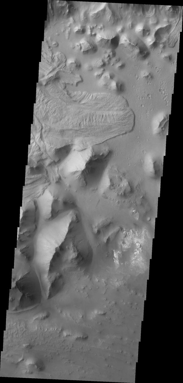 The landslide deposit in this image captured by NASA 2001 Mars Odyssey spacecraft is located in Aurorae Chaos distinctive area of broken terrain. Several regions of chaotic terrain are located on the eastern end of the Valles Marineris system.