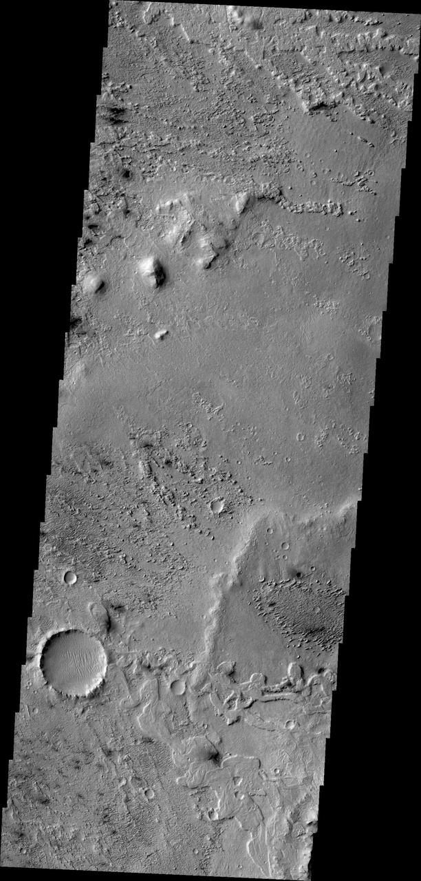 This image from NASA 2001 Mars Odyssey shows some of the effects that wind action has on the surface of Mars. This image is located near Zephyria Planum. Winds in the region have eroded and etched the surface materials.