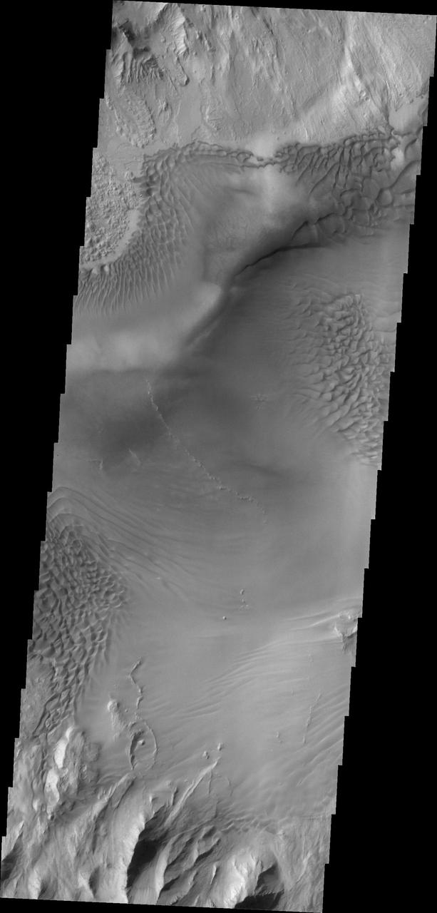 Baetis Chasma is a chasmata near but not directly connected to Valles Marineris. Dunes are prevalent on the floor of this portion of Juventae Chasma in this image taken by NASA 2001 Mars Odyssey.