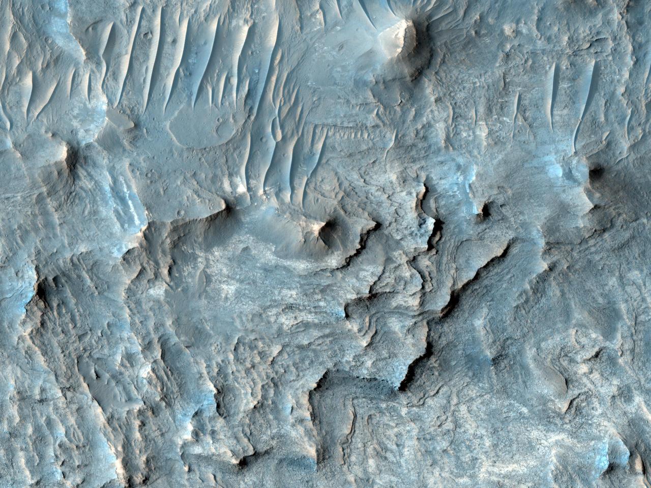 Ius Chasma is one of several canyons that make up Valles Marineris, the largest canyon system in the Solar System as seen by NASA Mars Reconnaissance Orbiter.