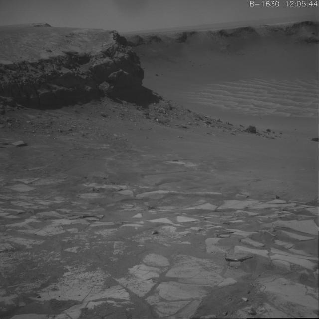 This image shows NASA Opportunity climb out of Victoria crater. It is the first frame of a movie that spans three days when the rover exited the crater at the alcove called Duck