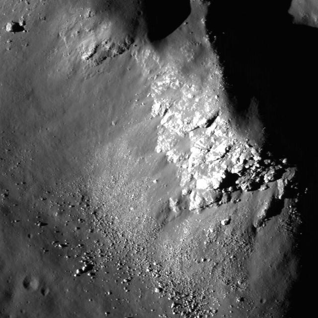 NASA Lunar Reconnaissance Orbiter captured this image close up view of Copernicus crater showing light-toned fractured bedrock exposed on the higher slopes on the central structural uplift.