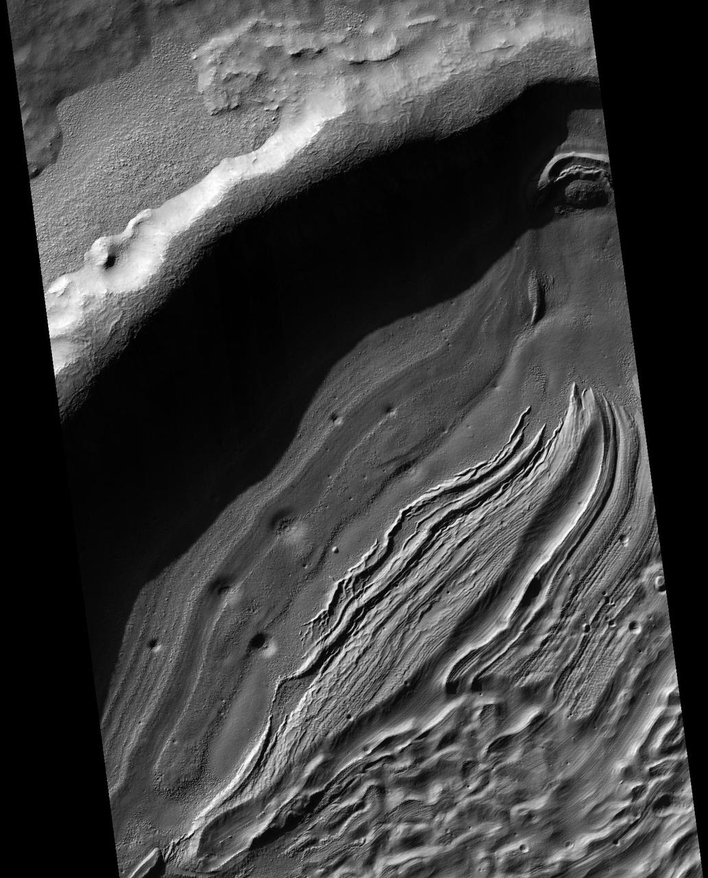 This image from NASA Mars Reconnaissance Orbiter covers a small portion of the northwest quadrant of Hellas Basin, or Hellas Planitia, on southern Mars; Hellas is one of the largest impact craters in the solar system.