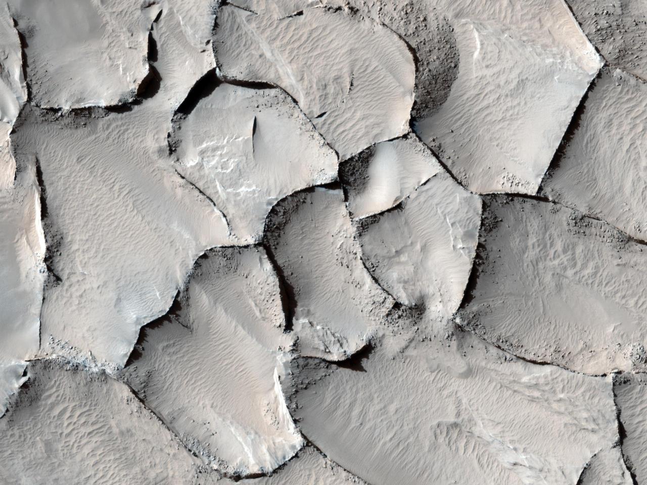 This image captured by NASA Mars Reconnaissance Orbiter from the Gordii Dorsum region of Mars shows a large area covered with polygonal ridges in an almost geometric pattern.