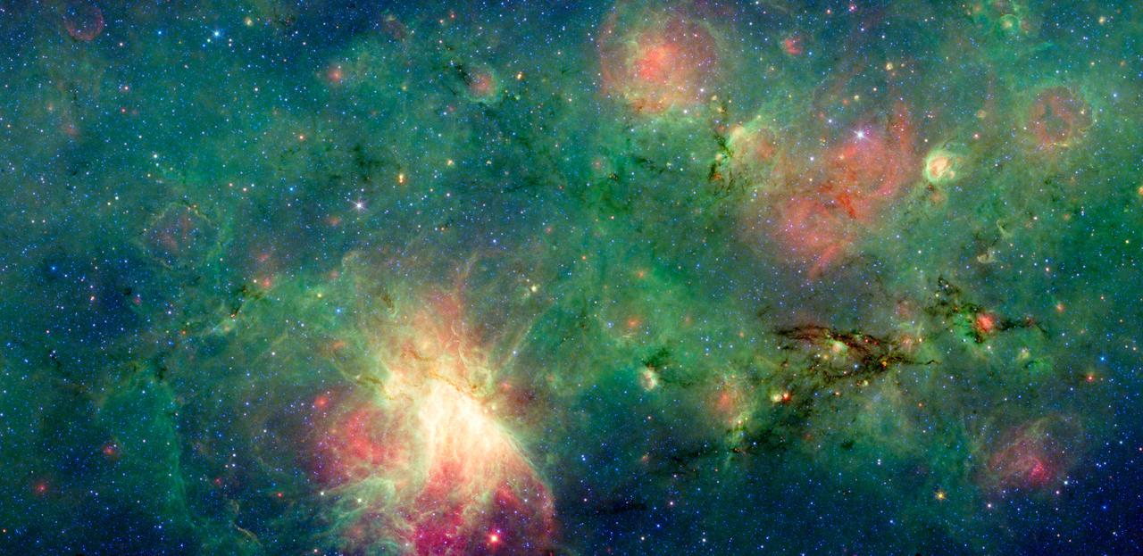 A dragon-shaped cloud of dust seems to fly out from a bright explosion in this infrared light image from NASA Spitzer Space Telescope. These views have revealed that this dark cloud, called M17 SWex, is forming stars at a furious rate.
