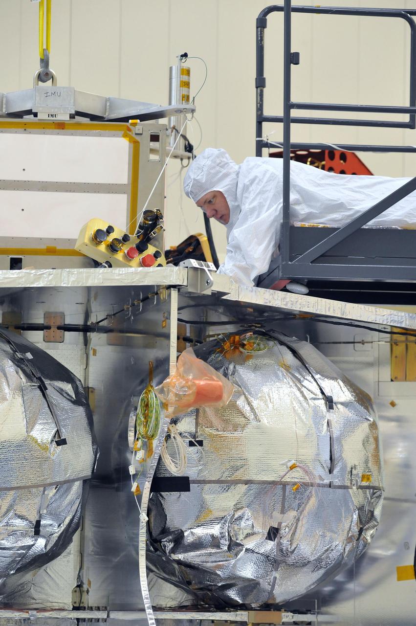 Technicians installed the special radiation vault for NASA Juno spacecraft on the propulsion module. The radiation vault has titanium walls to protect the spacecraft electronic brain and heart from Jupiter harsh radiation environment.