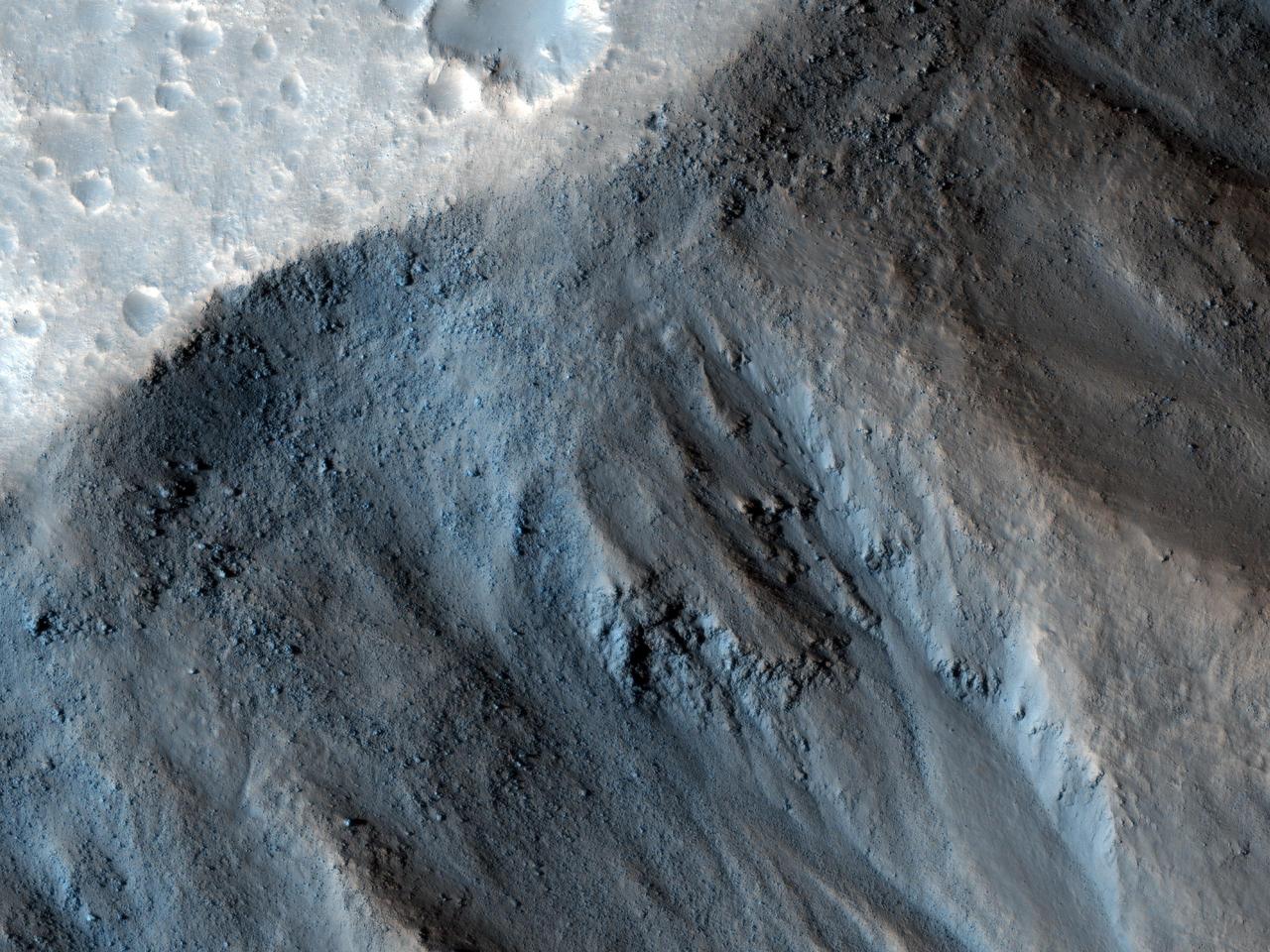 This observation from NASA Mars Reconnaissance Orbiter shows the very steep side of a plateau, part of the northern limit of the Kasei Valles system, which is one of the largest outflow channel systems on Mars.