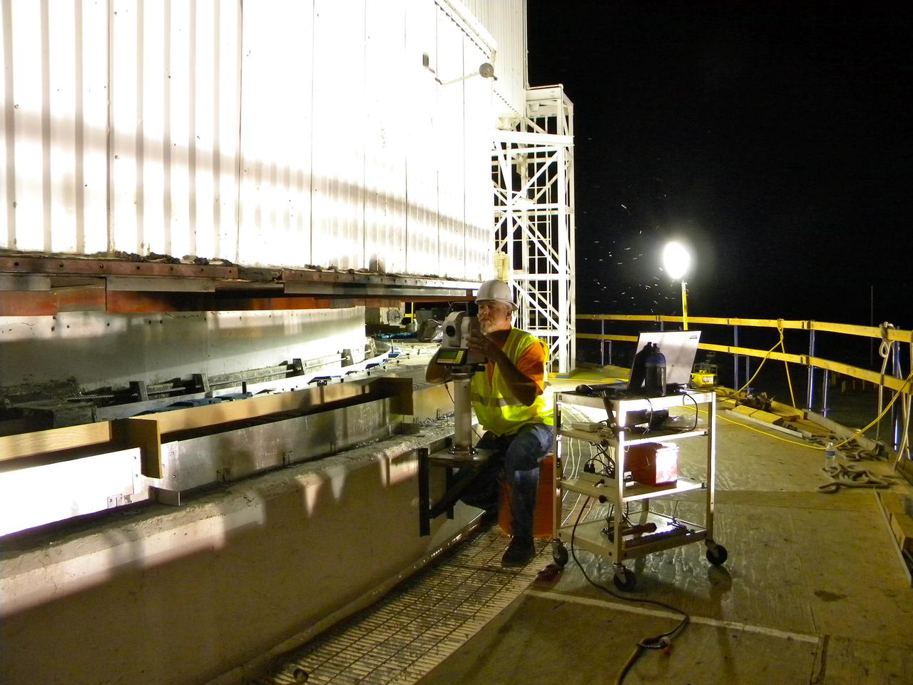 An engineer at NASA Jet Propulsion Laboratory in Pasadena, Calif., checks the evenness of sole plates installed on the giant Mars