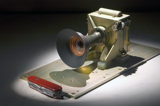 A pocketknife provides scale for this image of the Mars Descent Imager camera; the camera will fly on the Curiosity rover of NASA Mars Science Laboratory mission. Malin Space Science Systems, San Diego, Calif., supplied the camera for the mission.