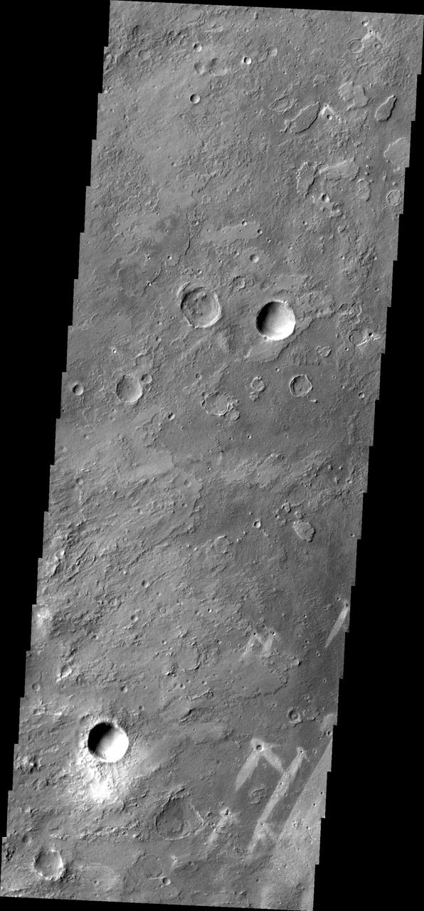 This image from NASA Mars Odyssey of part of Meridiani Planum contains windstreaks that formed in several directions around a single crater. This indicates that wind directions changed, forming new tails for each prevailing wind direction.