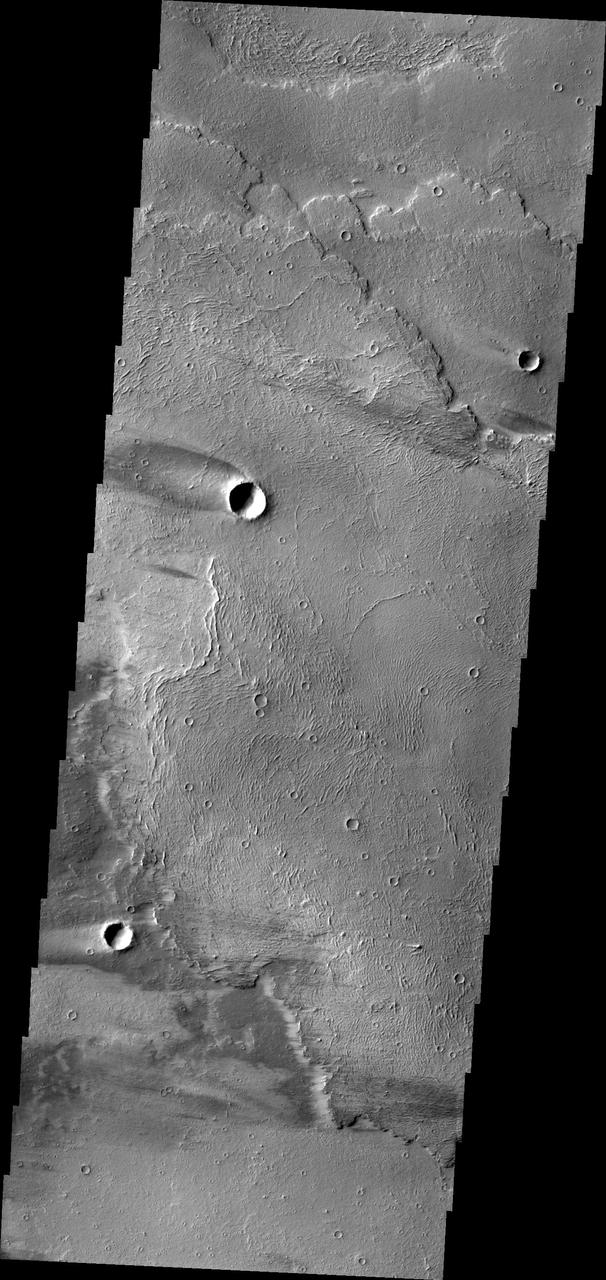 The windstreaks in this image captured by NASA Mars Odyssey are located on lava flows from Arsia Mons.