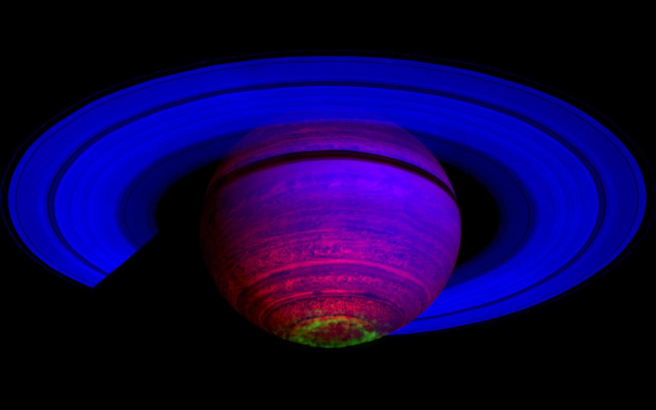 This false-color composite image, constructed from data obtained by NASA Cassini spacecraft, shows the glow of auroras streaking out about 1,000 kilometers 600 miles from the cloud tops of Saturn south polar region.