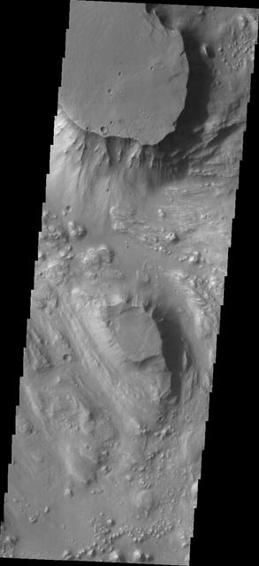 Located at the eastern end of Vallis Marineris is the region of chaos called Aurorae. This image from NASA Mars Odyssey is from the northern part of Aurorae Chaos and contains mesas separated by complex low lying regions.