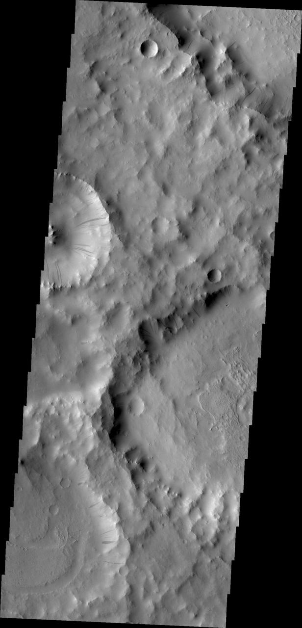 The gravity driven motion of material downhill has swept away some of the bright dust on the rim of this unnamed crater in Terra Sabaea as seen by NASA Mars Odyssey.