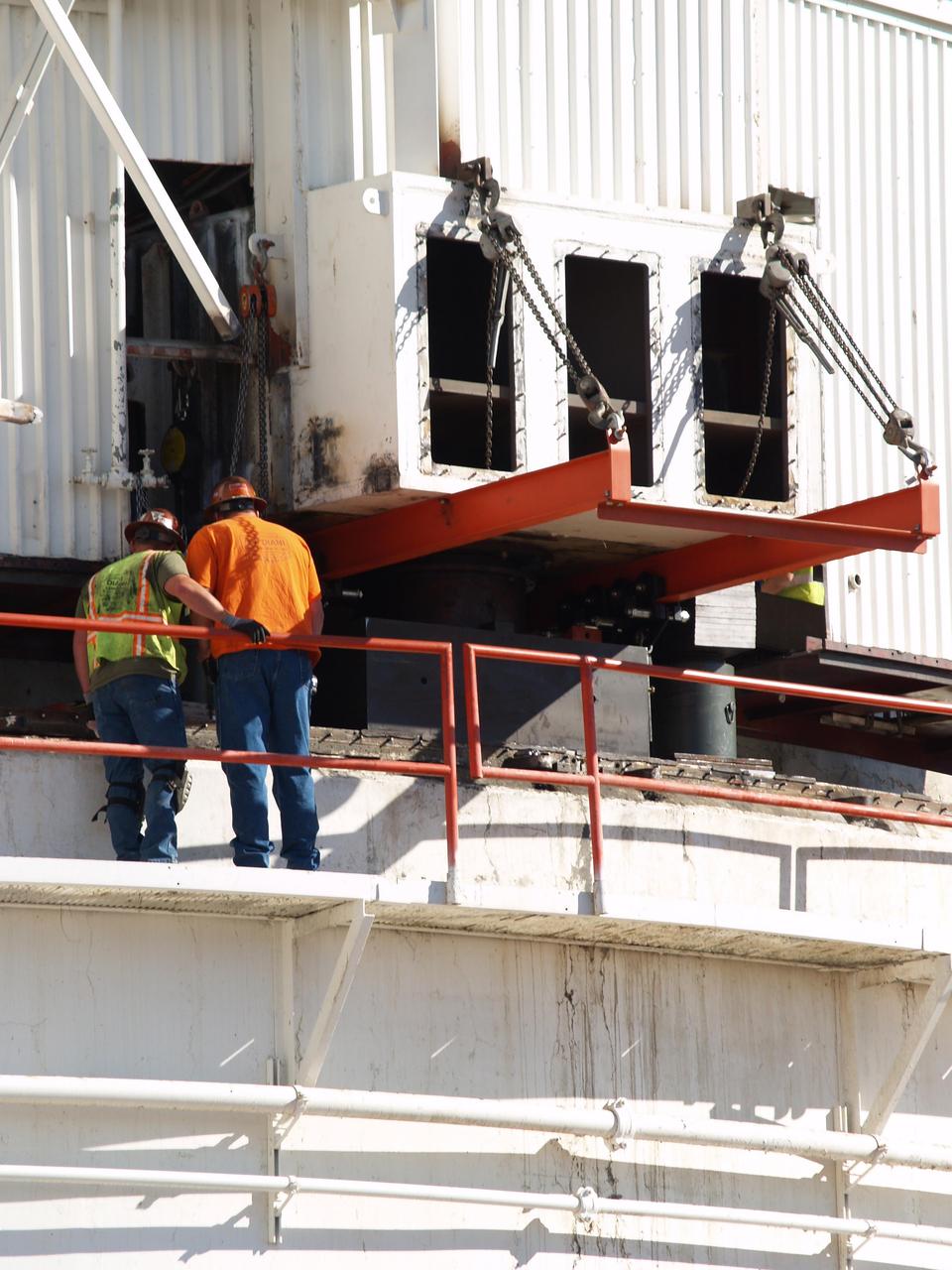 Workers at NASA Deep Space Network Goldstone Deep Space Communications Complex check on a set of jacks used to raise the upper part of the giant Mars antenna. 