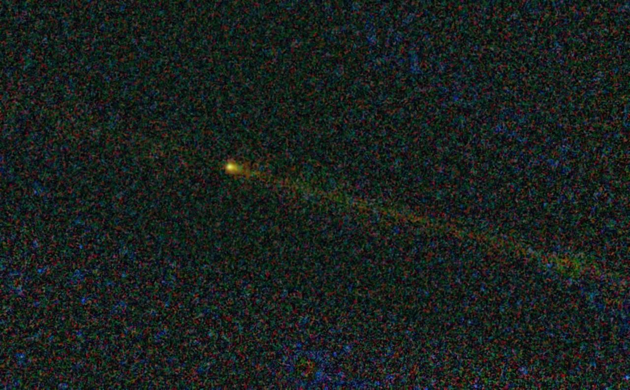 This visitor from deep space, seen here by NASA Wide-field Infrared Survey Explorer, is comet Hartley 2, the destination for NASA EPOXI mission. The comet tail is seen here as a fuzzy streak to the right of the comet.